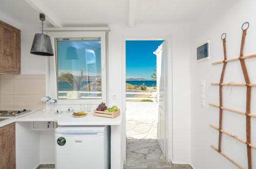 a kitchen with a view of the ocean at Saint George Hotel in Naxos Chora