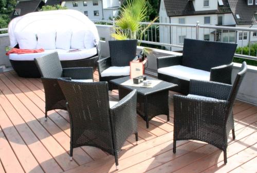 a deck with chairs and a table and a grill at Gasthof und Pension Zur Frischen Quelle in Heigenbrücken