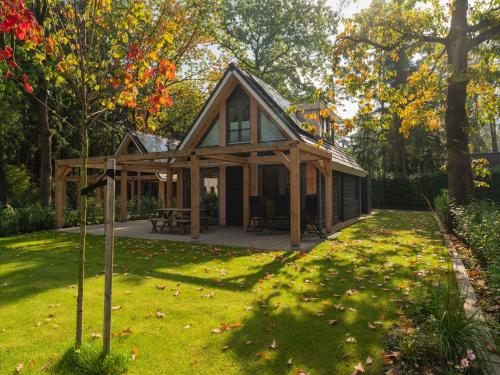 a small house in the middle of a yard at Holiday Home in Lochem with Garden View in Lochem