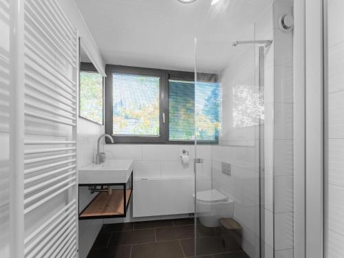 a white bathroom with a sink and a toilet at Holiday Home in Lochem with Garden View in Lochem