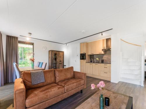a living room with a couch and a table at Holiday Home in Lochem with Garden View in Lochem