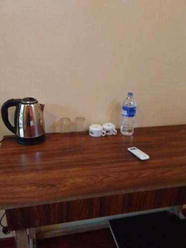 a table with a tea kettle and a bottle of water at Onilwe Resort Weligama in Weligama