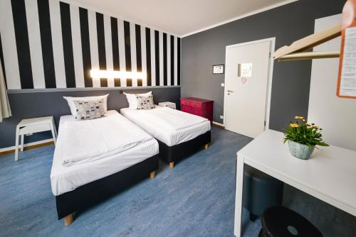 a hotel room with two beds and a fireplace at Old Town Hostel in Berlin