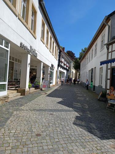 a cobblestone street in a town with buildings at Ferienwohnung zum Wohlfühlen in Lengerich