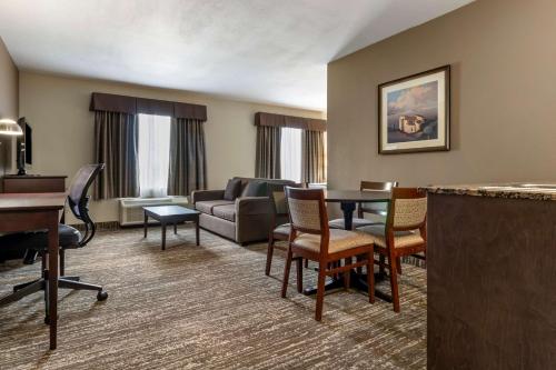 a living room with a couch and a table at Best Western Plus Pembina Inn & Suites in Winnipeg