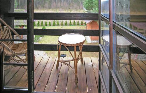 a wooden deck with a stool and chairs on a porch at Holiday Home Molza With Fireplace 02 in Molza