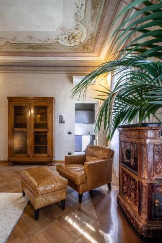 a living room with a couch and a chair at Villa Moro Lin Design Apartments in Mestre