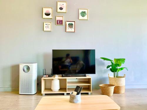a living room with a flat screen tv on a table at Deco Home @ Imago The Loft in Kota Kinabalu