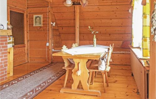 a wooden room with a table and two chairs at Gorgeous Home In Mucharz With Sauna in Mucharz