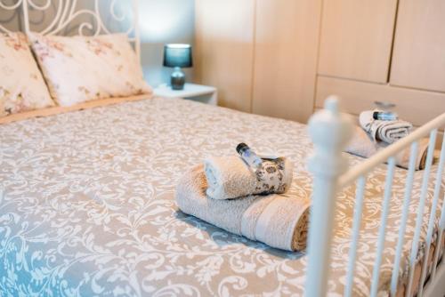 a bed with a crib with towels on it at Muses old town ioannina Urania in Ioannina