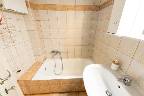 a bathroom with a tub and a sink at Muses old town ioannina Urania in Ioannina