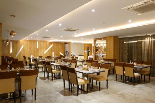 a restaurant with wooden walls and tables and chairs at HOTEL OCEAN VISTA BAY in Visakhapatnam