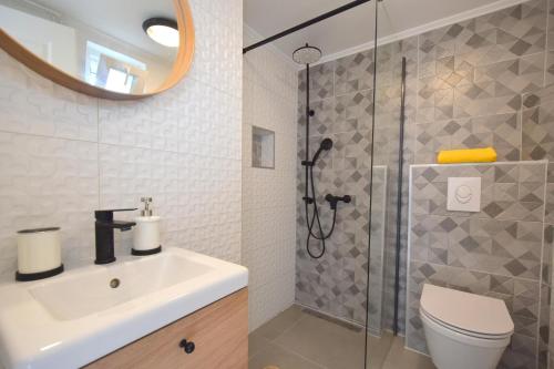 a bathroom with a sink and a shower at Apartments Julia in Čižići