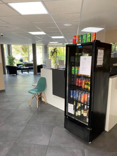 a refrigerator filled with lots of drinks in an office at Hotel Résidence Anglet Biarritz-Parme in Anglet