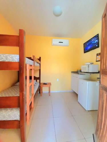 a kitchen with two bunk beds in a room at Pousada e Chalés Recantos do Mar in Barra Grande