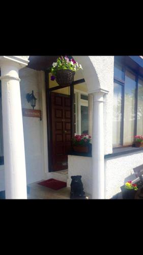 a front door of a house with potted plants on it at Glendale Guestrooms in Cushendall