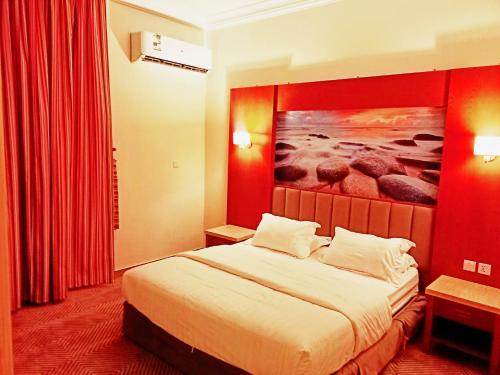 um quarto de hotel com uma cama e um quadro na parede em Taraf Yanbu 2 em Iambo