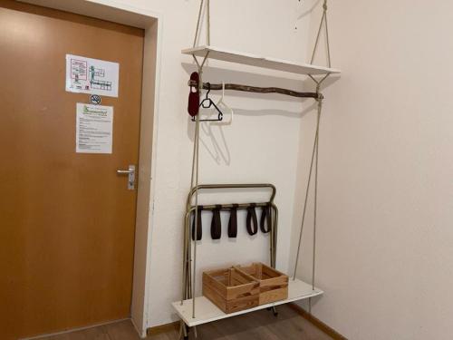 a room with a rack with utensils on a wall at Haus Sommerhof in Sindelfingen