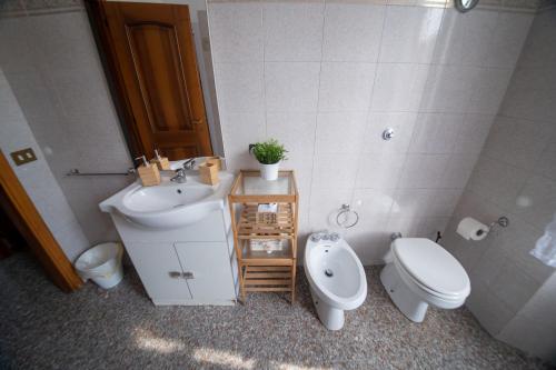 a bathroom with a toilet and a sink at DREAMS IN ROME - COLOSSEUM APARTMENT in Rome