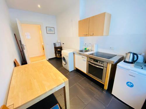 a kitchen with a sink and a dishwasher at BerlinLux Apartments - City in Berlin