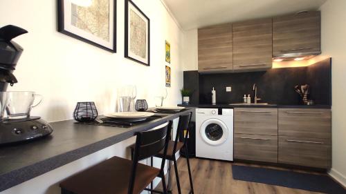 a kitchen with a washer and dryer on a counter at Nouveau* Vintage Mecanic* Wifi*Netflix*Confort in Venette