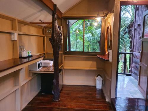 a small room with a table and a window at Malulee KhaoSok Resort in Khao Sok