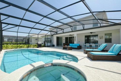 a large swimming pool with a glass roof at 2600YA Luxury Gorgeous Private Pool in Kissimmee