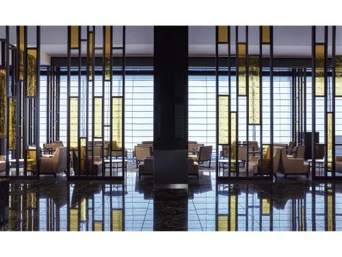 a lobby with chairs and tables in a building at Villa Fontaine Premier Haneda Airport in Tokyo