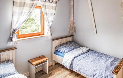 a bedroom with two beds and a window at 3 Bedroom Amazing Home In Kopalino in Kopalino