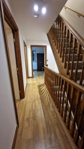 a hallway with a wooden staircase in a house at 3-Bedroom Family Holiday Home in Skegness