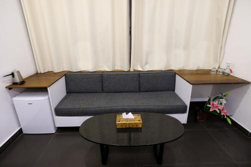 a living room with a couch and a table at Hamra Urban Gardens in Beirut