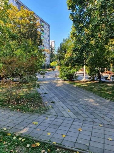 a cobblestone street in a park with a building at MIA apartment in Skopje
