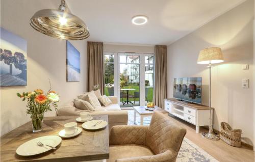 a living room with a couch and a table at Baltischer Hof Apartment 13 in Boltenhagen