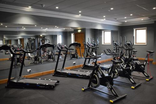 a gym with a bunch of tread machines in a room at Paradise Bay Resort in Mellieħa
