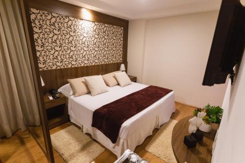 Postel nebo postele na pokoji v ubytování JR Hotel Ribeirão Preto