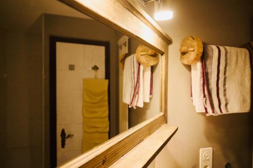 a mirror in a bathroom with towels on a wall at Charmant petit appartement à Grimentz au pied des pistes in Grimentz