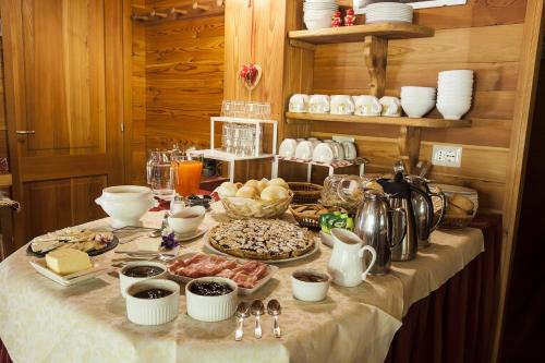 a table with a buffet of food on it at Agriturismo Alagna in Alagna Valsesia