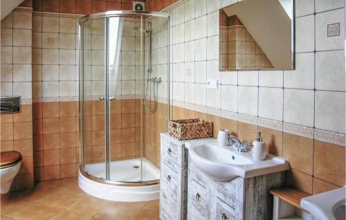 a bathroom with a sink and a shower and a toilet at Nice Home In Jedwabno With 3 Bedrooms in Jedwabno