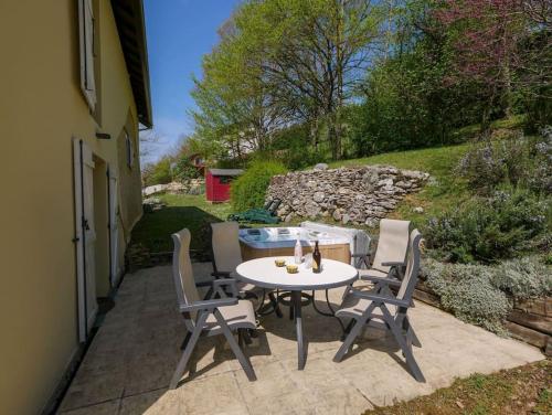 a table and chairs sitting on a patio at Gite des Marronniers in Dizimieu