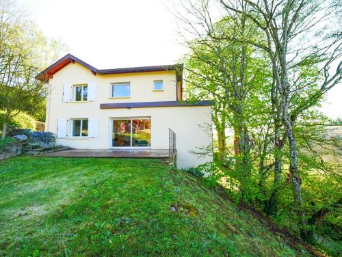a large white house with a yard and trees at Gite des Marronniers in Dizimieu