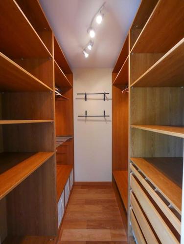 a walk in closet with wooden shelves and a door at Gite des Marronniers in Dizimieu