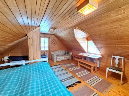 a bedroom with a bed in a wooden cabin at Pikkuturska in Kalajoki