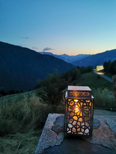 a lantern sitting on a rock with a view of a mountain at Maison de charme à Séez avec vue sur montagne, cheminée in Séez