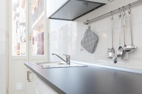 a kitchen with a sink and a counter with utensils at Maison Cavalleggeri in Rome