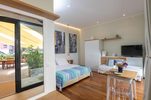 a hotel room with a bed and a balcony at Locanda da Toto in Genova