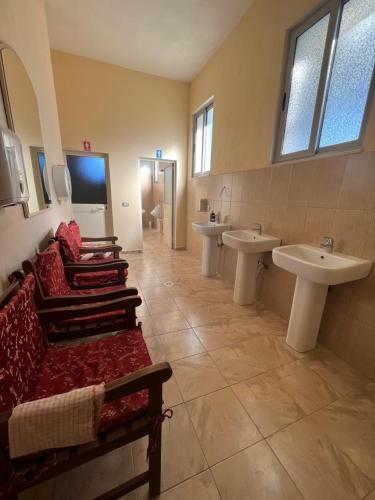 a large bathroom with two sinks and two mirrors at Hotel Garden Albania in Golem