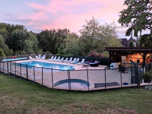 a large swimming pool with chairs and a gazebo at Pagel in Catus