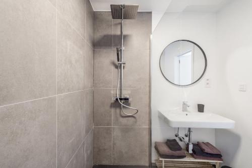 a bathroom with a shower and a sink at Delightful family apartment at only 50 meters from the beach / Panne A Côte in De Panne