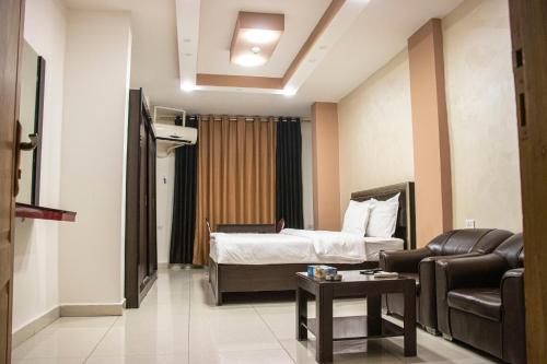a hotel room with a bed and a couch at Sara Crown Hotel in Irbid