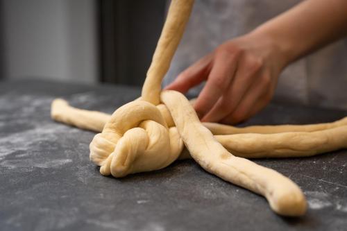 a person making a bunch of uncooked dough at Pension Cäcilia in Pöllau